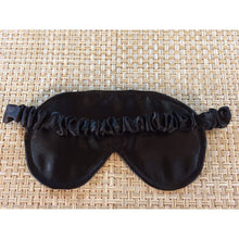 Load image into Gallery viewer, The back view of a black satin eye sleep mask showing the elastic strap that is covered by black satin.
