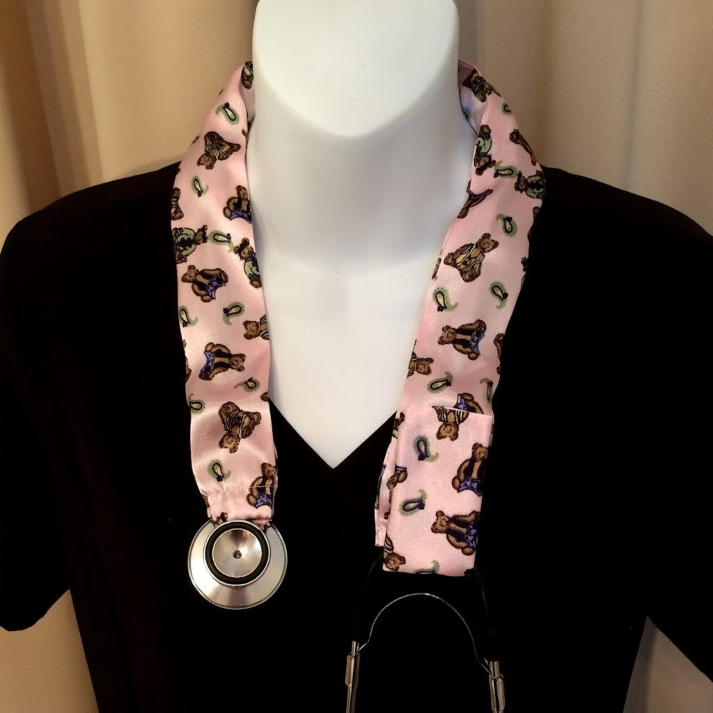 A pink with little bears stethoscope cover.  The cover is hanging on a mannequin.