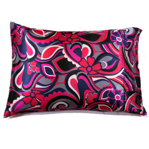 A decorative pillow with a magenta, red, navy blue and white flowers print satin cover. The pillow measures 12" x 16".