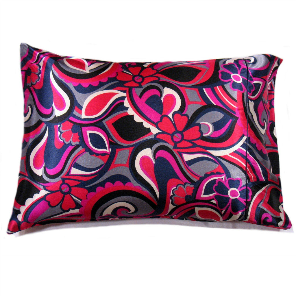 A decorative pillow with a magenta, red, navy blue and white flowers print satin cover. The pillow measures 12