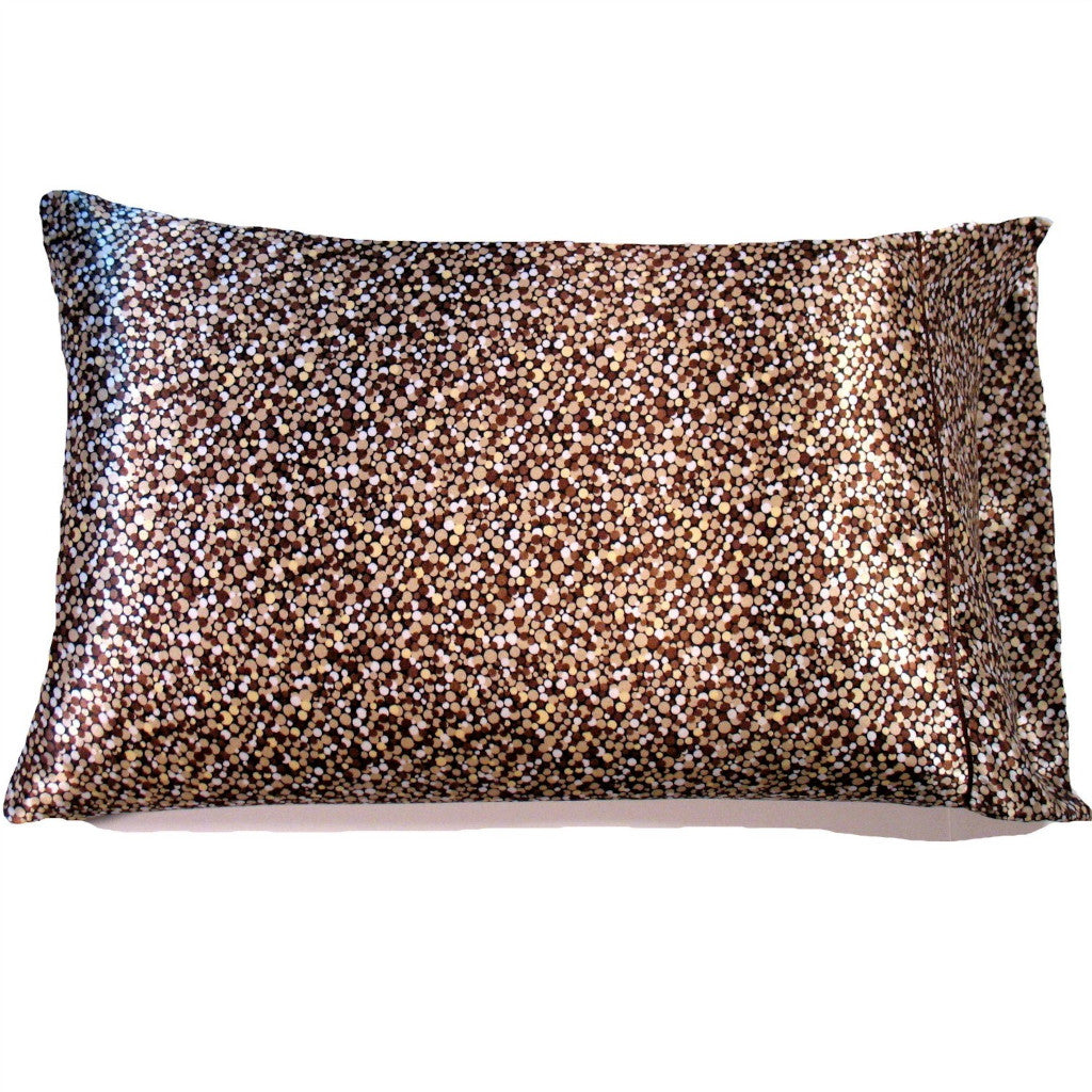 A throw pillow with a brown, beige and white various small dots cover. The pillow measures 12