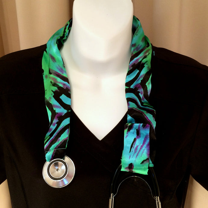 Our stethoscope cover is made from a green, purple and turquoise blue charmeuse satin zebra print and is washable. The cover has a Velcro closing to keep it in place.