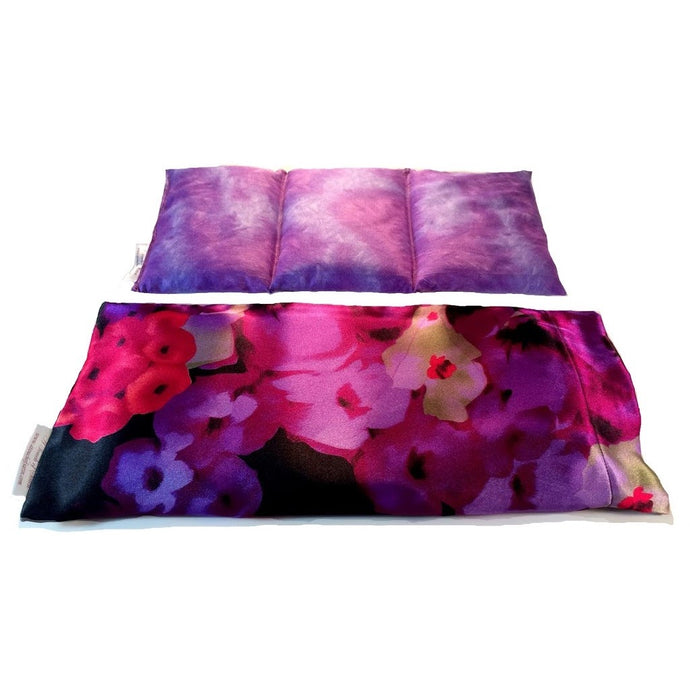 Pink and purple flowers therapy wrap. Behind the wrap is an insert, sewn into three sections with a muted purple and blue cover.