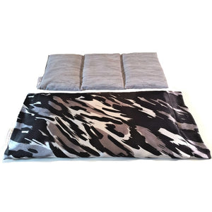 A therapy wrap with a white, black and gray satin cover. Behind the wrap is a cotton insert in gray. The insert is sewn in three sections.
