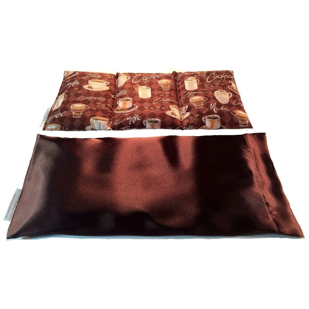 A heating pad with a dark brown satin cover. Behind the heating pad is a cotton insert. The insert is sewn in three sections. The cotton cover has pictures of coffee cups, the word coffee and mocha on the cover as well.