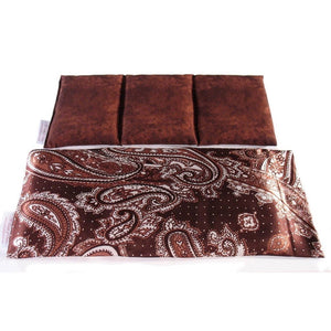 A therapy wrap in a brown and white paisley print cover. Behind the wrap is a cotton insert. The insert is sewn in three sections. The cover of the insert is dark and light brown.