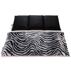 Therapy wrap in a black and white zebra satin cover. Behind the wrap is a cotton insert. The insert is sewn in three sections. This makes sure the organic flaxseed stays in place. The insert has a black cover.